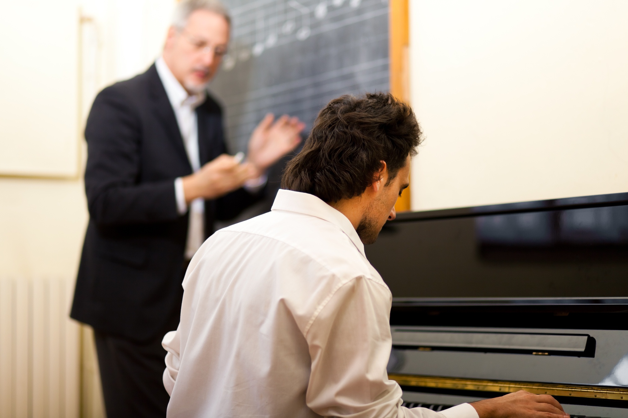 A pianist learning from a teacher