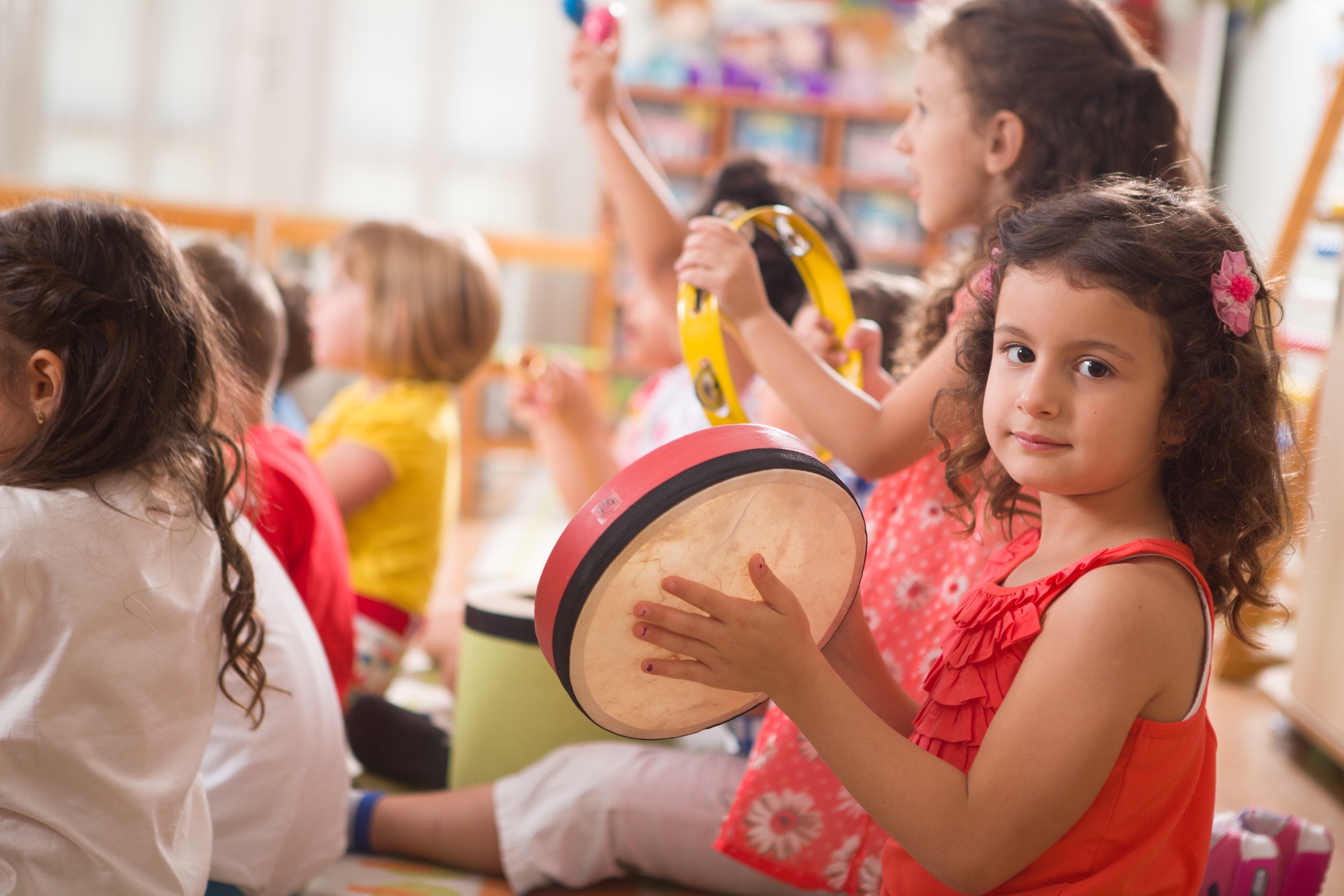 Early childhood music kids having fun with instruments