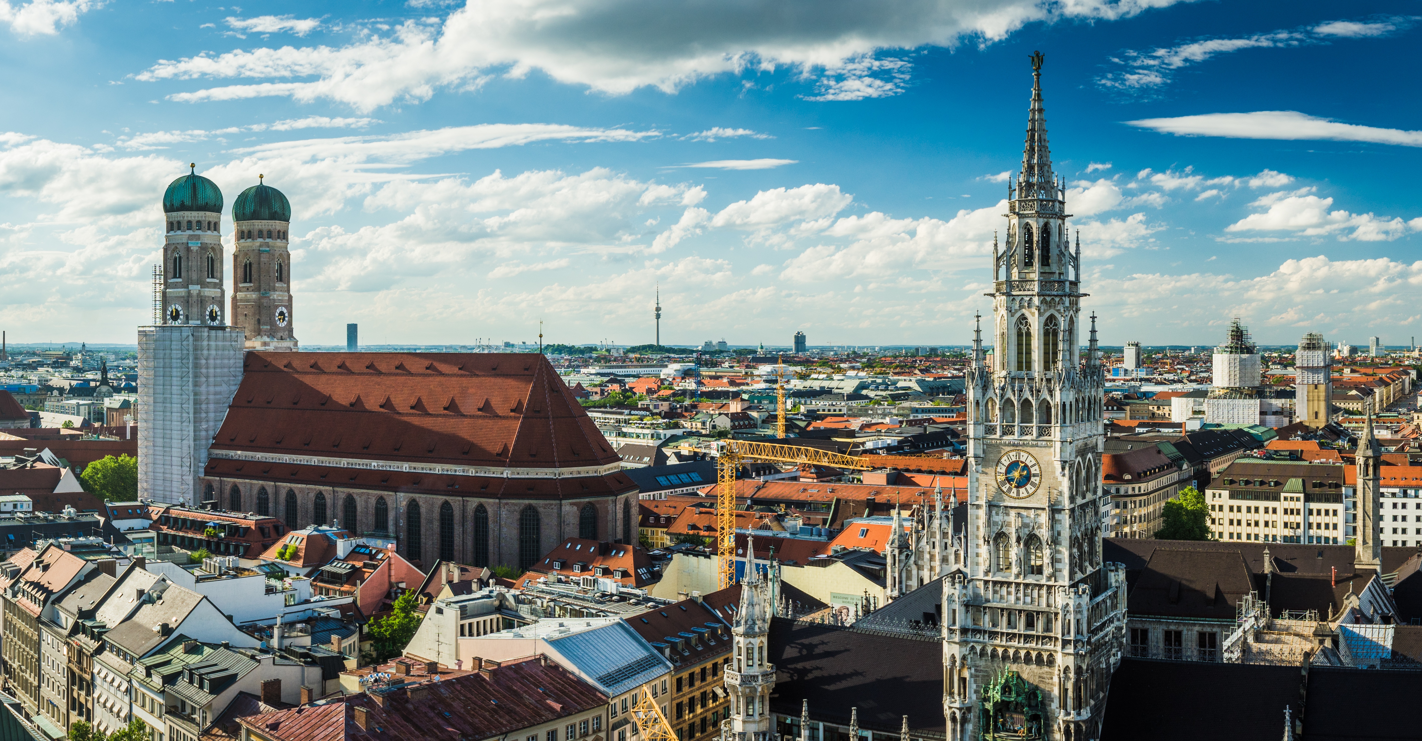 View over roofs in Munich. Churches, red roof tiles.