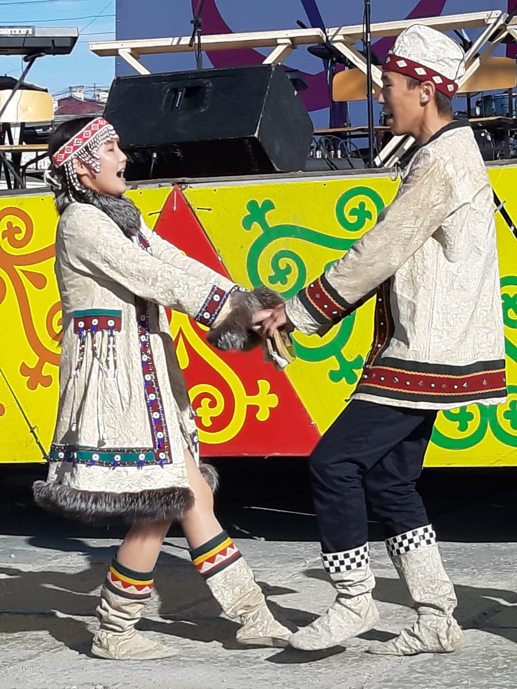 Two children in local costume in Yakutsk singing and dancing