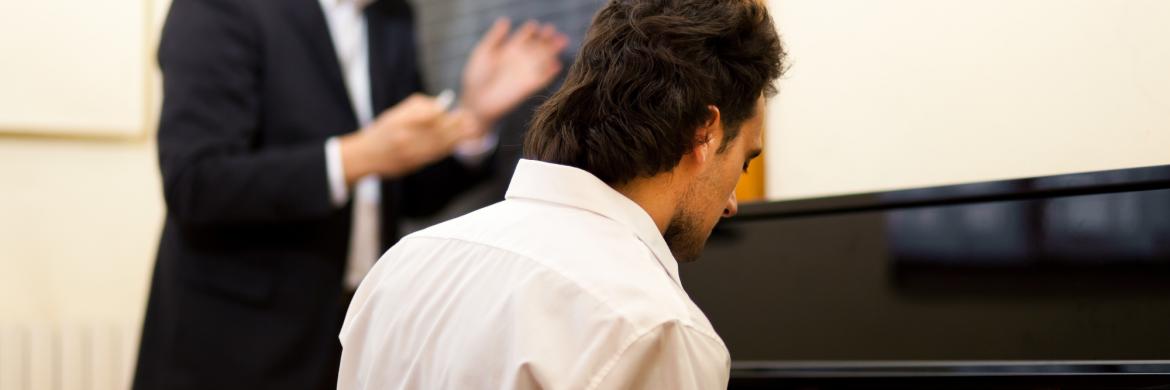 A pianist learning from a teacher