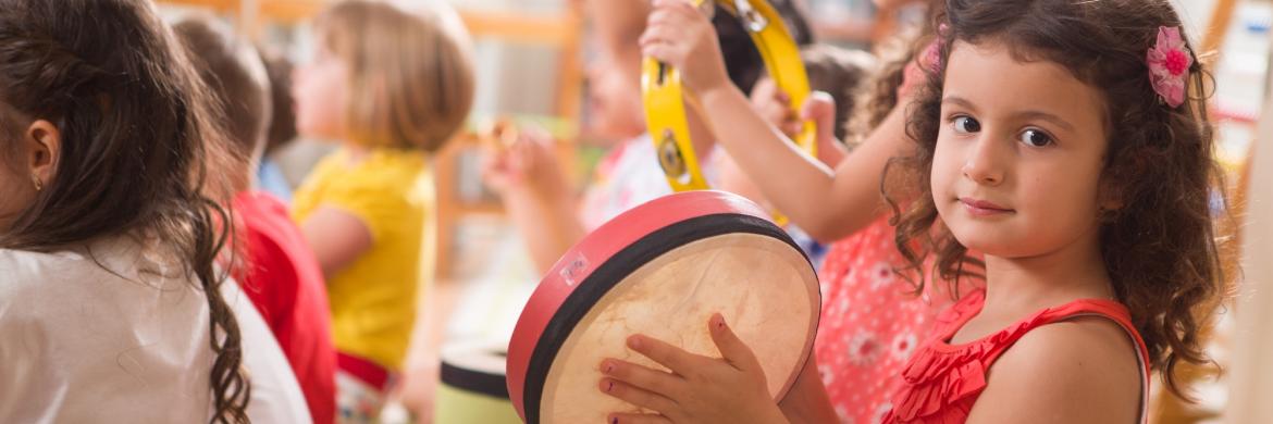 Early childhood music kids having fun with instruments