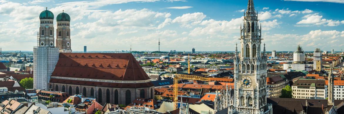 View over roofs in Munich. Churches, red roof tiles.