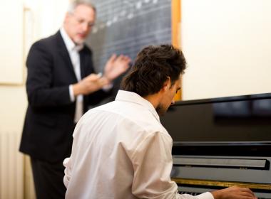 A pianist learning from a teacher