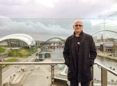 Dave Camlin on a bridge with Sage behind him