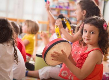 Early childhood music kids having fun with instruments