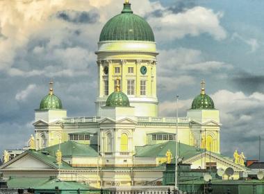 Helsinki Cathedral against a dramatic blue and cloudy sky