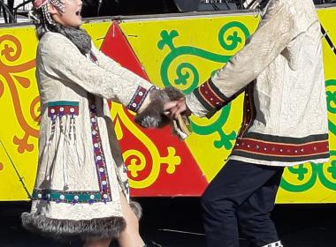 Two children in local costume in Yakutsk singing and dancing