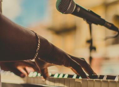 hands playing keyboard and microphone